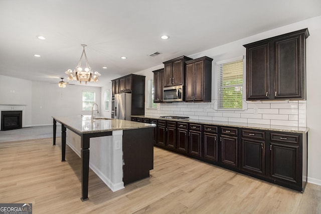 2113 Dodson Woods Dr, Fairburn, GA 30213 - kitchen featuring an inviting chandelier, light wood-style flooring, stainless steel appliances, visible vents, and decorative backsplash