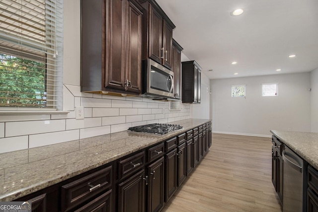 2113 Dodson Woods Dr, Fairburn, GA 30213 - kitchen featuring baseboards, recessed lighting, light wood-style floors, and appliances with stainless steel finishes