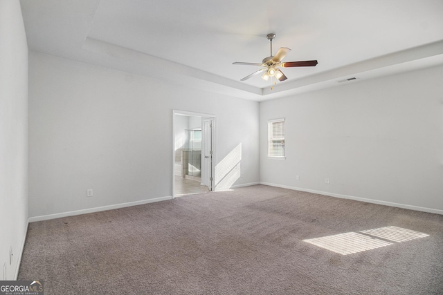 2113 Dodson Woods Dr, Fairburn, GA 30213 - carpeted spare room with a ceiling fan, visible vents, baseboards, and a raised ceiling