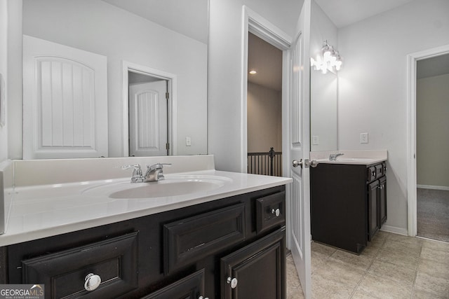 2113 Dodson Woods Dr, Fairburn, GA 30213 - bathroom featuring baseboards, two vanities, and a sink