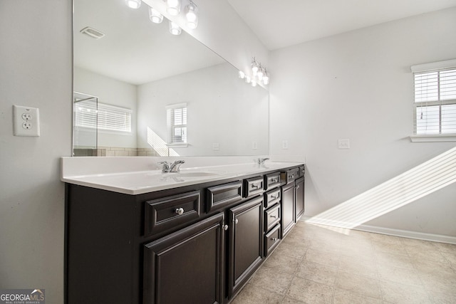2113 Dodson Woods Dr, Fairburn, GA 30213 - bathroom featuring a sink, double vanity, baseboards, and visible vents