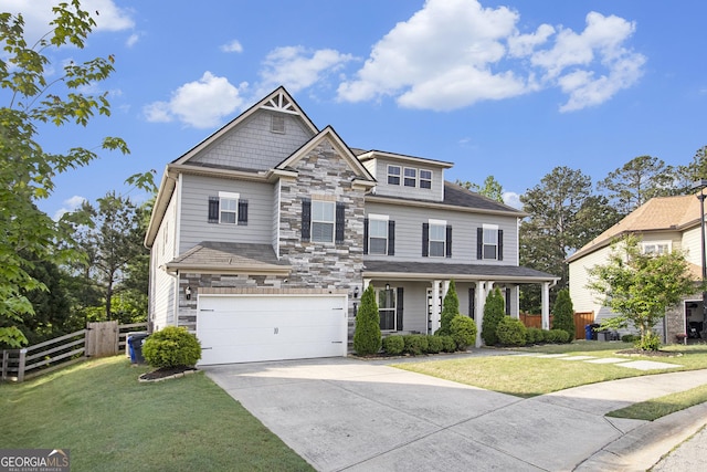 2113 Dodson Woods Dr, Fairburn, GA 30213 - craftsman-style home with stone siding, a front yard, fence, and an attached garage