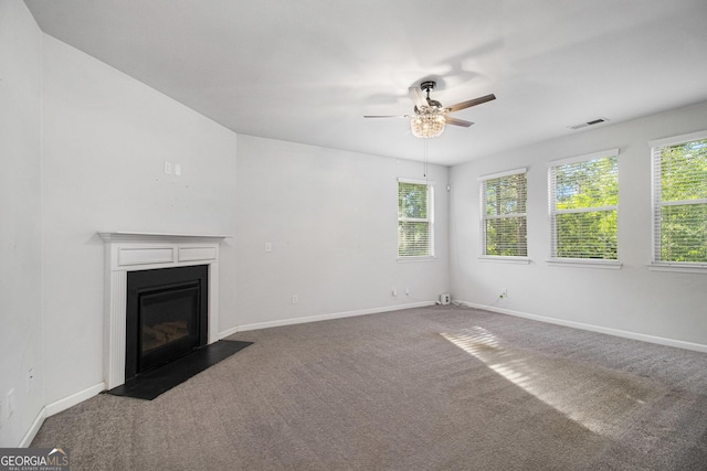 2113 Dodson Woods Dr, Fairburn, GA 30213 - unfurnished living room with a fireplace with flush hearth, carpet flooring, a ceiling fan, and visible vents