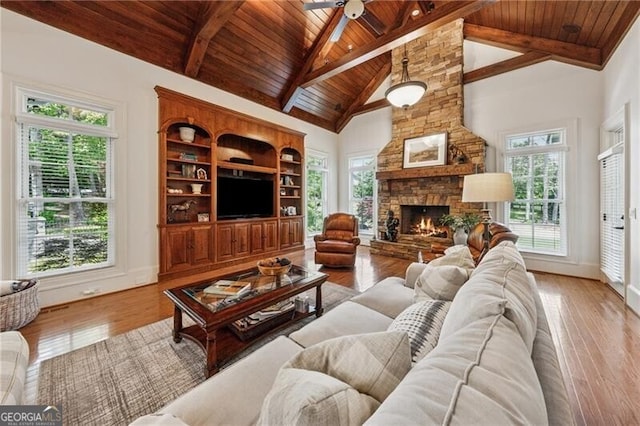 living room featuring ceiling fan, wood finished floors, wood ceiling, and beam ceiling