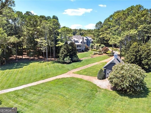 view of property's community with a yard