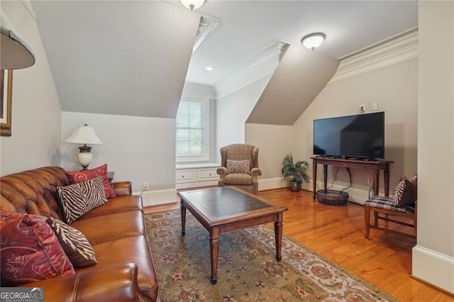living area featuring crown molding, baseboards, wood finished floors, and lofted ceiling