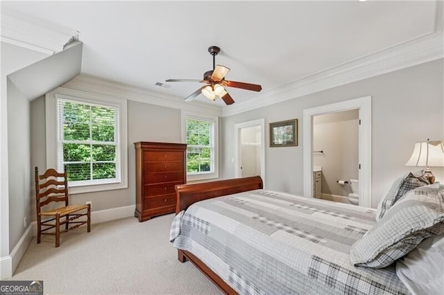 carpeted bedroom featuring crown molding, connected bathroom, baseboards, and ceiling fan