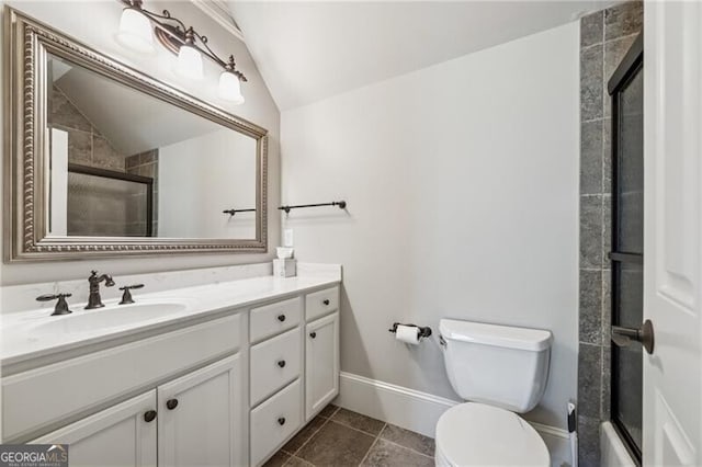 full bathroom featuring toilet, vanity, tile patterned floors, vaulted ceiling, and tiled shower