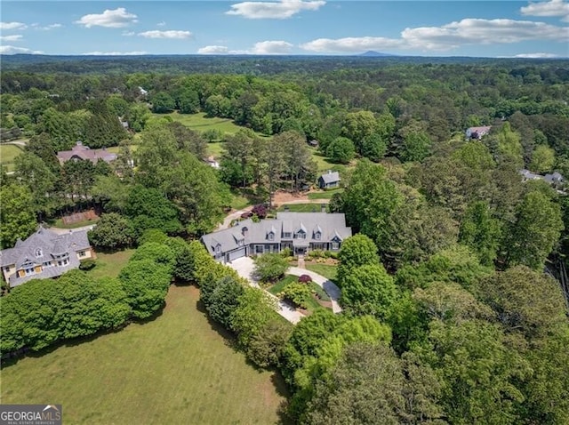 bird's eye view featuring a wooded view