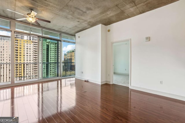 950 W Peachtree St NW Unit 1214, Atlanta, GA 30309 - unfurnished room with wood finished floors, a view of city, ceiling fan, floor to ceiling windows, and baseboards