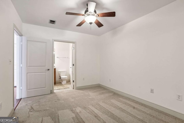950 W Peachtree St NW Unit 1214, Atlanta, GA 30309 - unfurnished bedroom featuring a ceiling fan, carpet floors, ensuite bathroom, visible vents, and baseboards