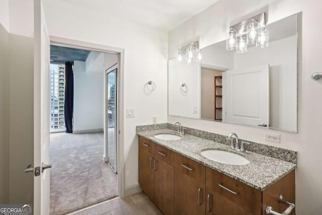 950 W Peachtree St NW Unit 1214, Atlanta, GA 30309 - full bath featuring a sink, double vanity, baseboards, and tile patterned flooring