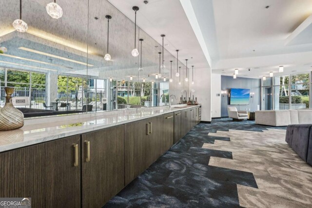 950 W Peachtree St NW Unit 1214, Atlanta, GA 30309 - bar featuring carpet floors, a sink, and decorative light fixtures