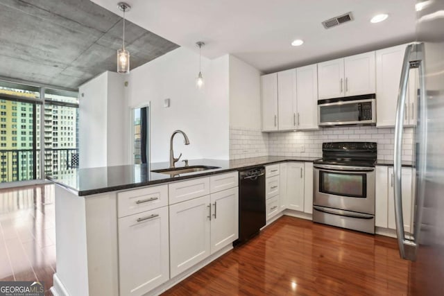 950 W Peachtree St NW Unit 1214, Atlanta, GA 30309 - kitchen featuring visible vents, a sink, a peninsula, decorative backsplash, and stainless steel appliances