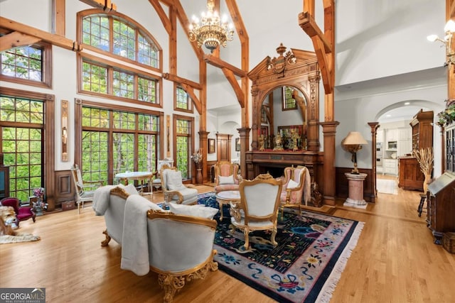 3863 Streamside Dr SE, Marietta, GA 30067 - interior space featuring wainscoting, light wood finished floors, a towering ceiling, and a notable chandelier