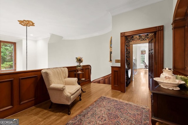 3863 Streamside Dr SE, Marietta, GA 30067 - living area featuring light wood finished floors, crown molding, and wainscoting