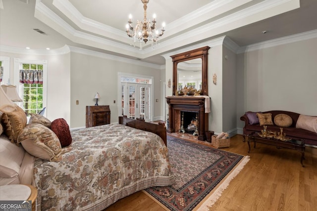 3863 Streamside Dr SE, Marietta, GA 30067 - bedroom featuring an inviting chandelier, visible vents, wood finished floors, and crown molding
