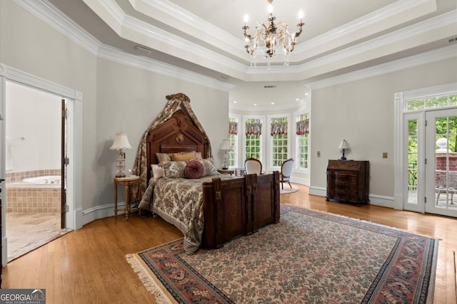 3863 Streamside Dr SE, Marietta, GA 30067 - bedroom featuring access to outside, a chandelier, crown molding, a raised ceiling, and light wood-style floors