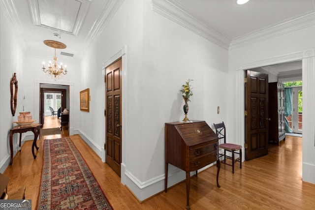 3863 Streamside Dr SE, Marietta, GA 30067 - corridor featuring attic access, a notable chandelier, crown molding, light wood-type flooring, and visible vents
