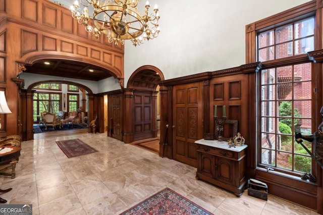3863 Streamside Dr SE, Marietta, GA 30067 - foyer featuring a chandelier, a towering ceiling, and arched walkways