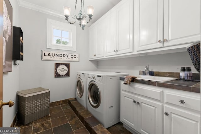 3863 Streamside Dr SE, Marietta, GA 30067 - washroom featuring a sink, cabinet space, stone tile flooring, independent washer and dryer, and a chandelier