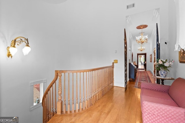 3863 Streamside Dr SE, Marietta, GA 30067 - hall featuring a notable chandelier, an upstairs landing, visible vents, and wood finished floors