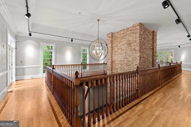 3863 Streamside Dr SE, Marietta, GA 30067 - hallway with wood finished floors, rail lighting, an upstairs landing, a chandelier, and a wealth of natural light