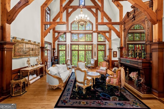 3863 Streamside Dr SE, Marietta, GA 30067 - sitting room featuring a wainscoted wall, a chandelier, wood finished floors, and high vaulted ceiling