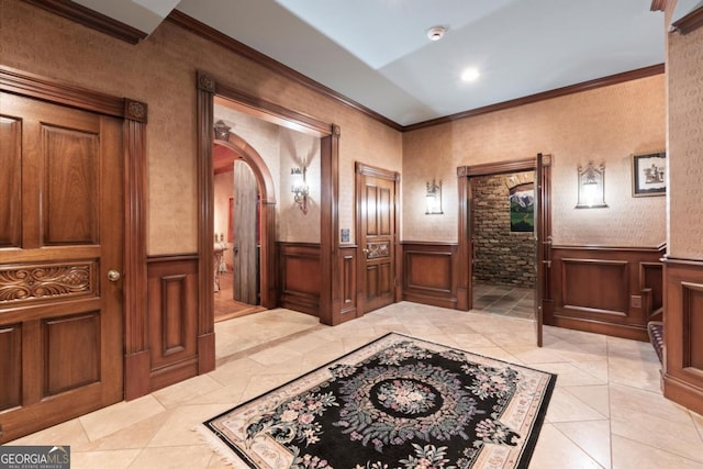 3863 Streamside Dr SE, Marietta, GA 30067 - foyer entrance featuring light tile patterned flooring, ornamental molding, wainscoting, and arched walkways
