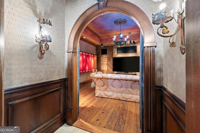 3863 Streamside Dr SE, Marietta, GA 30067 - interior space featuring arched walkways, an inviting chandelier, wood-type flooring, and wainscoting
