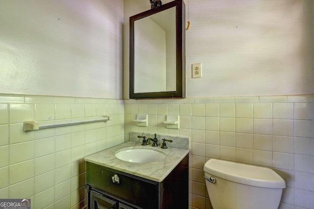 1815 Windsor Dr SW, Atlanta, GA 30311 - bathroom featuring tile walls, toilet, vanity, and a wainscoted wall