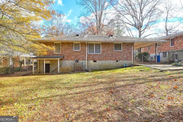 1815 Windsor Dr SW, Atlanta, GA 30311 - back of property with a lawn, an attached carport, and brick siding