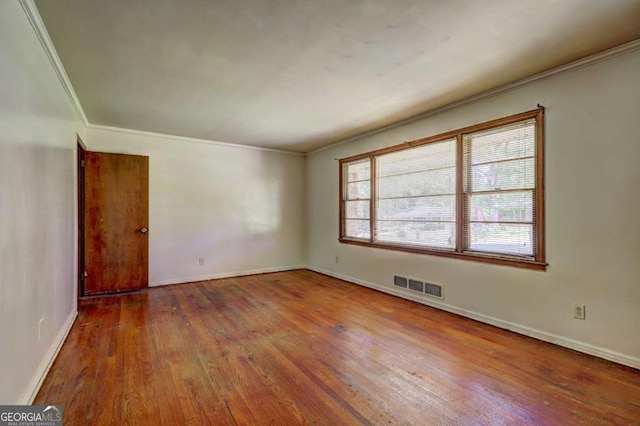 1815 Windsor Dr SW, Atlanta, GA 30311 - unfurnished room with baseboards, crown molding, wood-type flooring, and visible vents