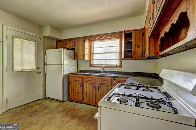 1815 Windsor Dr SW, Atlanta, GA 30311 - kitchen featuring brown cabinets, white appliances, light wood-style flooring, and a sink