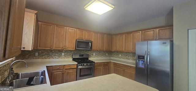 7491 Hilltop Way, Atlanta, GA 30349 - kitchen featuring appliances with stainless steel finishes, tasteful backsplash, light countertops, and a peninsula