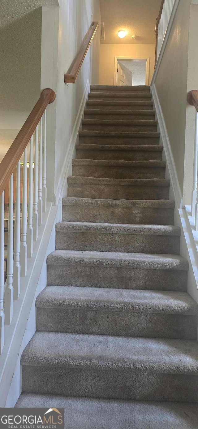 7491 Hilltop Way, Atlanta, GA 30349 - stairs featuring baseboards