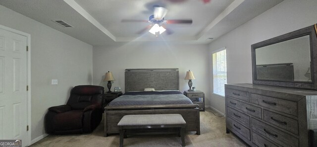 7491 Hilltop Way, Atlanta, GA 30349 - bedroom with a tray ceiling, light carpet, and a ceiling fan
