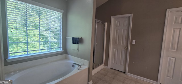 7491 Hilltop Way, Atlanta, GA 30349 - bathroom featuring a bath, a stall shower, and tile patterned floors