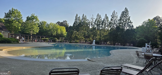 7491 Hilltop Way, Atlanta, GA 30349 - community pool featuring a patio area and view of scattered trees