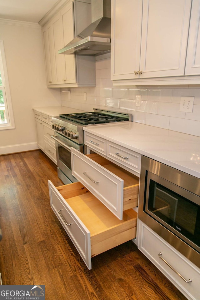 1468 N Amanda Cir, Atlanta, GA 30329 - kitchen featuring backsplash, light countertops, appliances with stainless steel finishes, and wall chimney exhaust hood