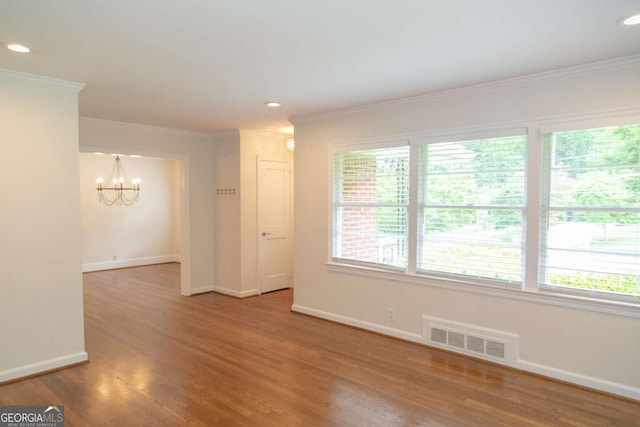 1468 N Amanda Cir, Atlanta, GA 30329 - empty room featuring wood finished floors, visible vents, baseboards, a chandelier, and ornamental molding