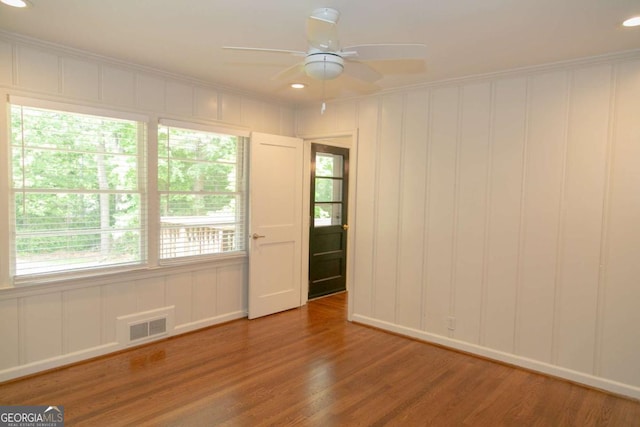 1468 N Amanda Cir, Atlanta, GA 30329 - empty room featuring ceiling fan, a decorative wall, visible vents, and wood finished floors