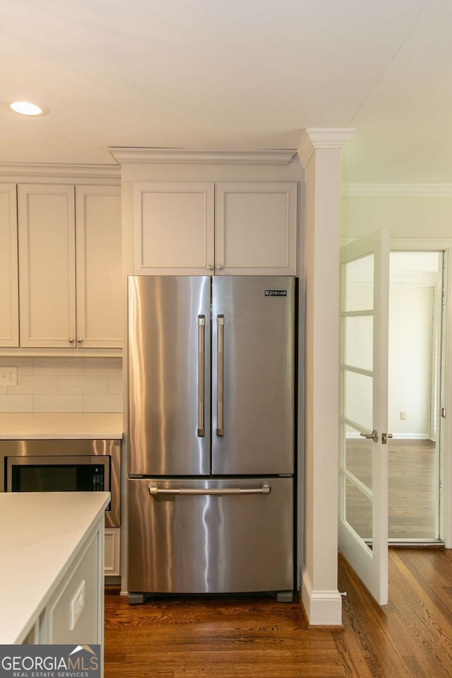 1468 N Amanda Cir, Atlanta, GA 30329 - kitchen with crown molding, dark wood finished floors, light countertops, and appliances with stainless steel finishes