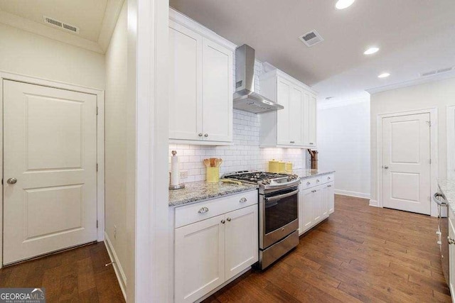 kitchen with recessed lighting, stainless steel gas range, baseboards, decorative backsplash, and wall chimney exhaust hood