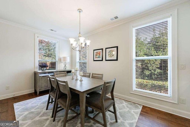 dining space with an inviting chandelier, visible vents, baseboards, and ornamental molding