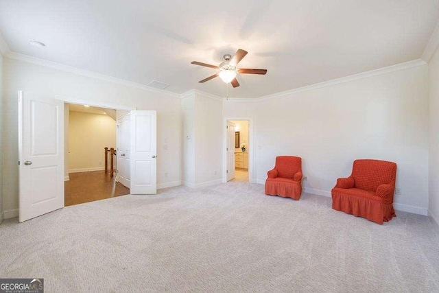 living area featuring carpet flooring, crown molding, baseboards, and a ceiling fan