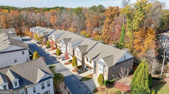 aerial view with a wooded view and a residential view