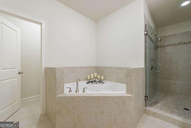 bathroom featuring a bath, tile patterned flooring, a stall shower, and recessed lighting