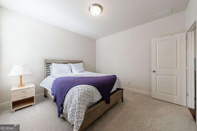 carpeted bedroom with visible vents and baseboards