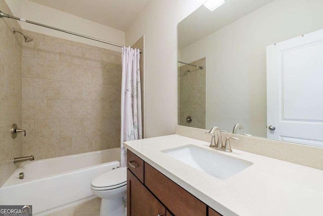 full bathroom with toilet, shower / tub combo with curtain, and vanity